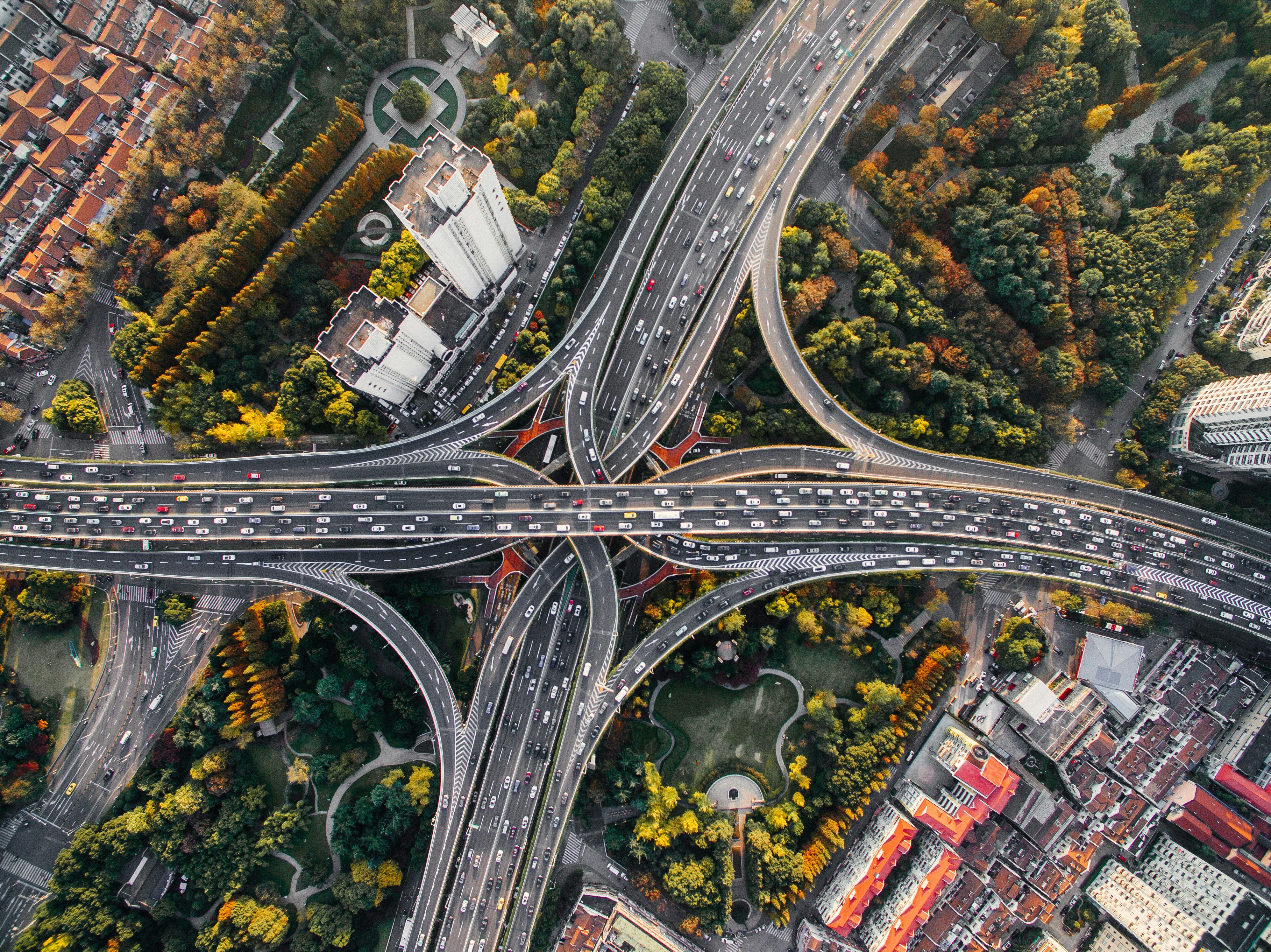 Aerial view of highway lanes converging into a single interchange, representing framework standardisation