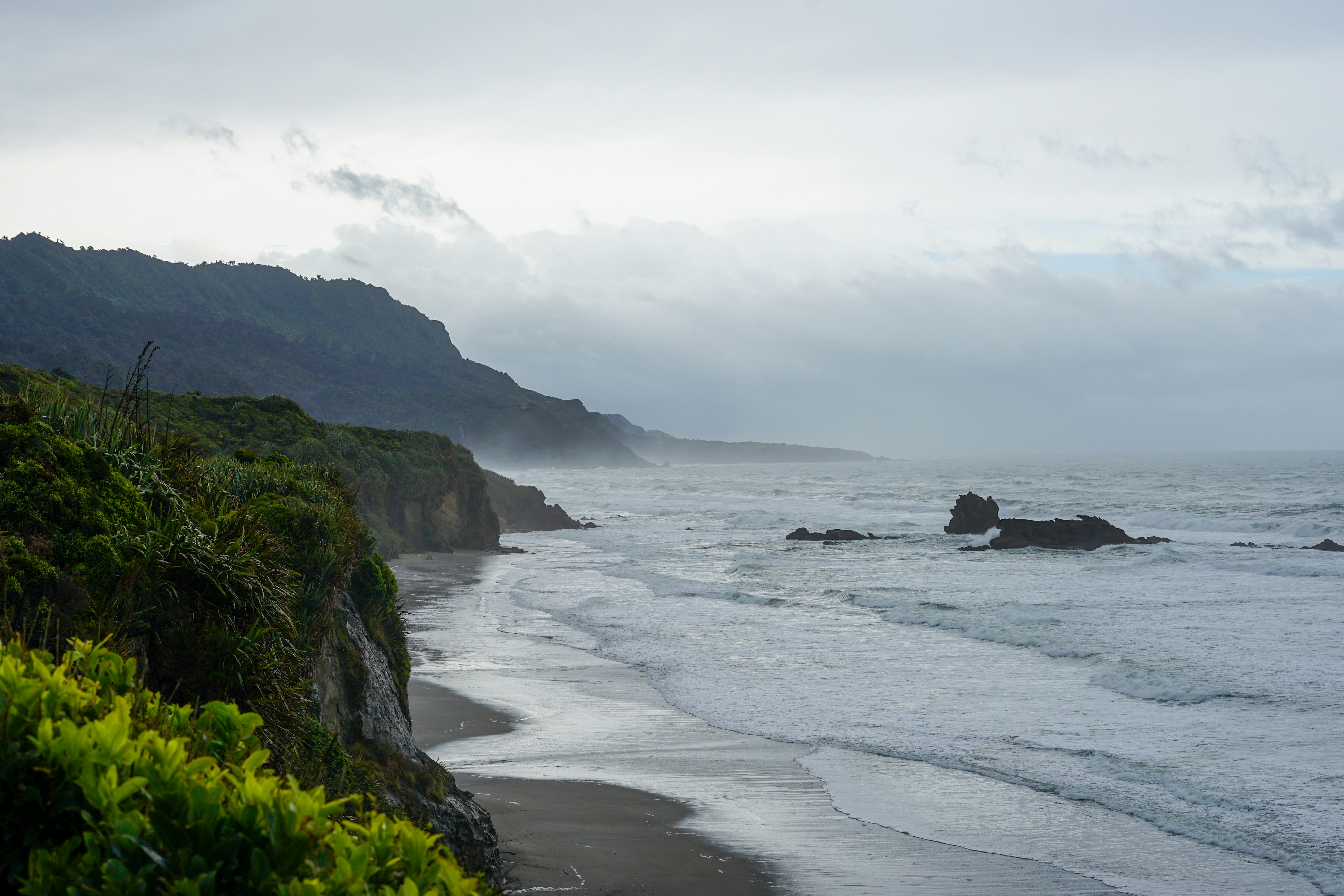 Moody coastline with cliff edge disappearing into mist, boundary between land and sea