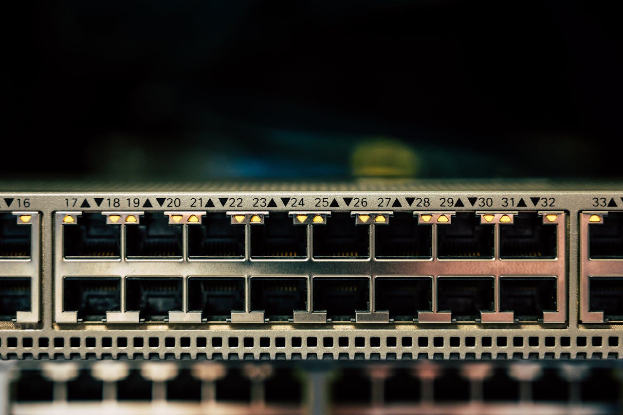 Close-up of network switch ports with glowing LED indicators and connected ethernet cables